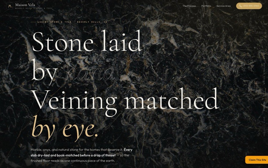 Dark, editorial tile & stone website with a champagne-gold headline reading Craftsmanship set in stone